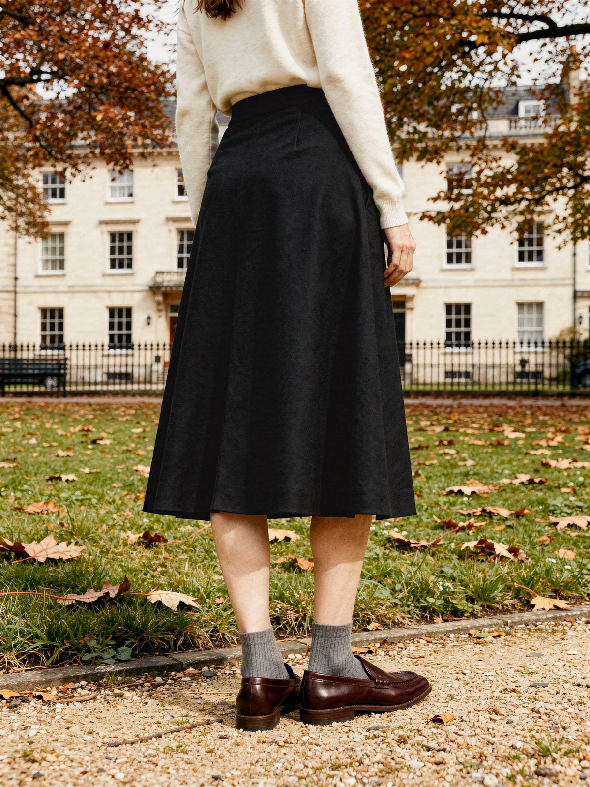 Black wool skirt seen from behind in a Georgian garden square, Jackdaw, Northleach by Harlbury