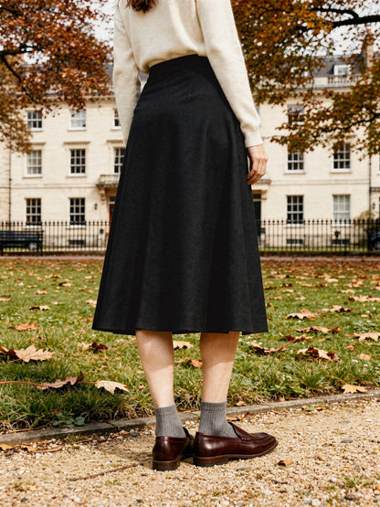 Black wool skirt seen from behind in a Georgian garden square, Jackdaw, Northleach by Harlbury