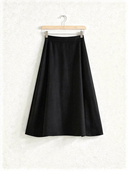Black wool blend A-line midi skirt on a wooden hanger, Jackdaw, Northleach by Harlbury