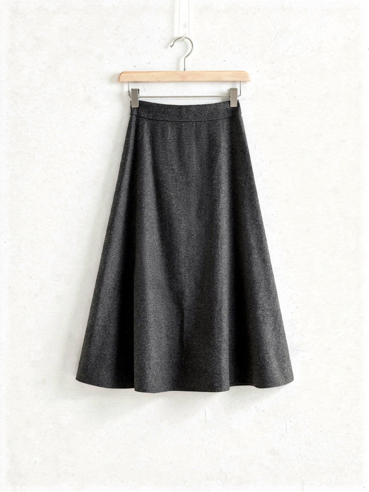 Charcoal wool blend A-line midi skirt on a wooden hanger, Whinstone, Northleach by Harlbury