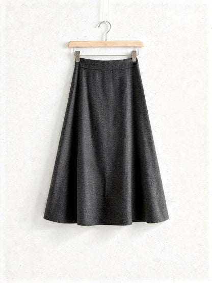 Charcoal wool blend A-line midi skirt on a wooden hanger, Whinstone, Northleach by Harlbury