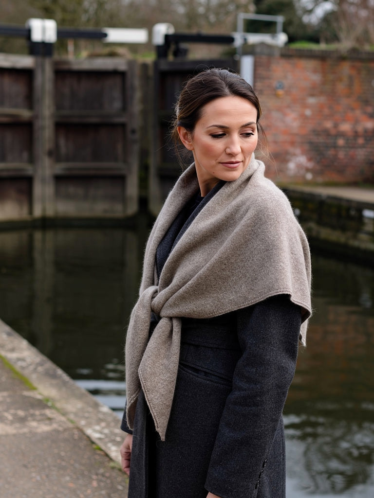 Womens wool triangle scarf in Moleskin knotted over a charcoal wool coat on a canal towpath