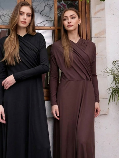 The wrap dress worn in black and in cherrywood brown side by side