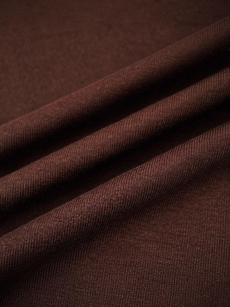 Close up of the fine matte jersey of the wrap dress in cherrywood brown