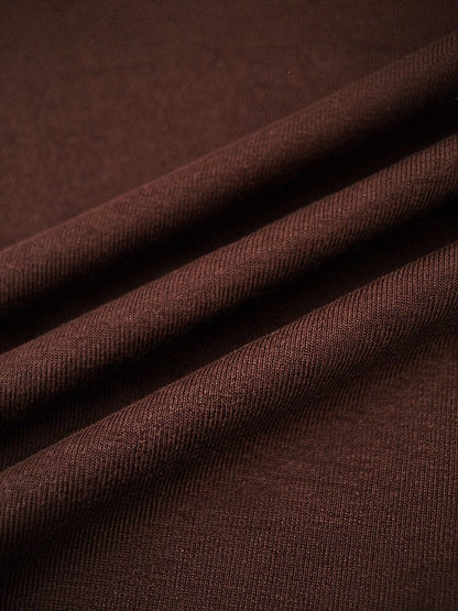 Close up of the fine matte jersey of the wrap dress in cherrywood brown
