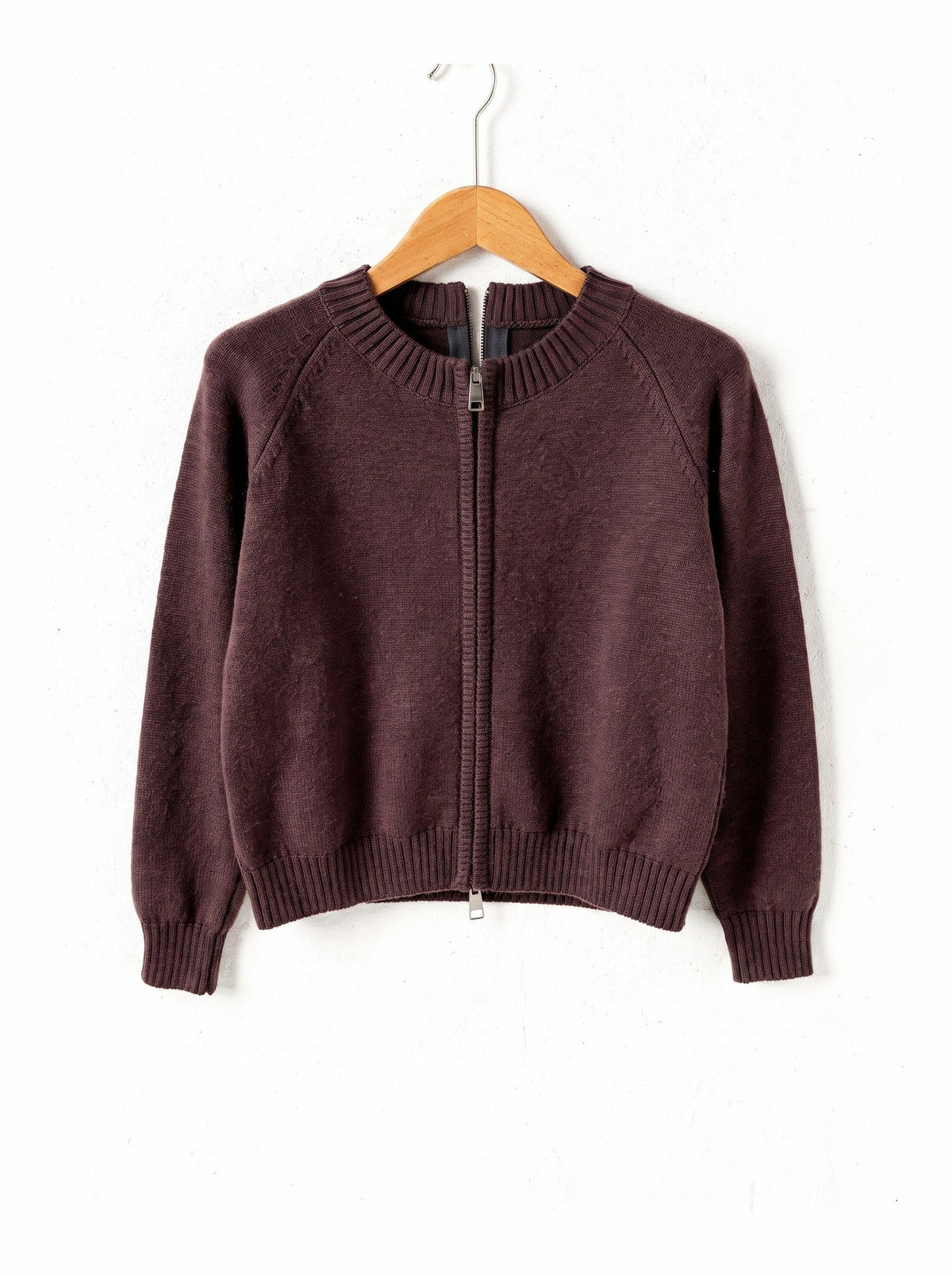 Cotton-rich zip-through cardigan in Cordovan brown on a plain wooden hanger