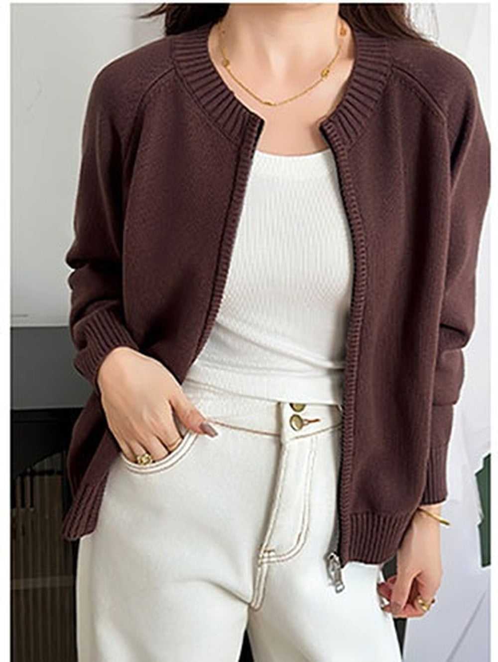 Cotton-rich zip-through cardigan in Cordovan brown, worn open with off-white trousers