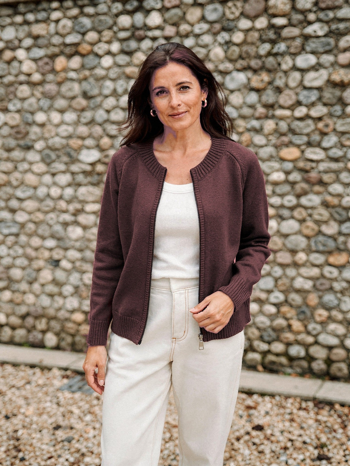 Zip-through cardigan in cotton-rich Cordovan brown, worn open over a cream vest top