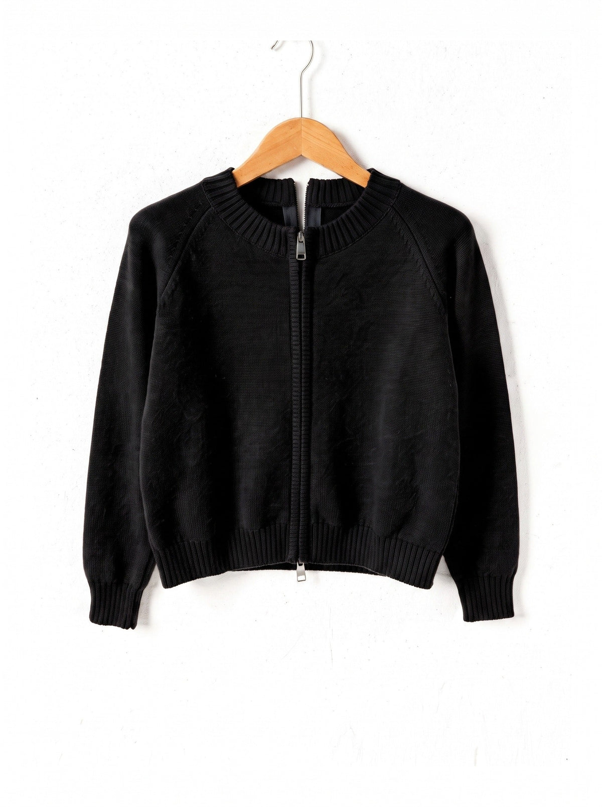 Zip-through cardigan in Liquorice black on a plain wooden hanger